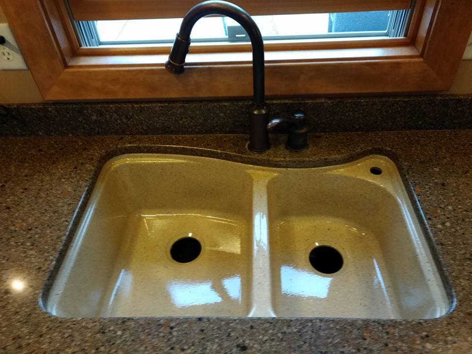Composite sink refinished with faux stone coating